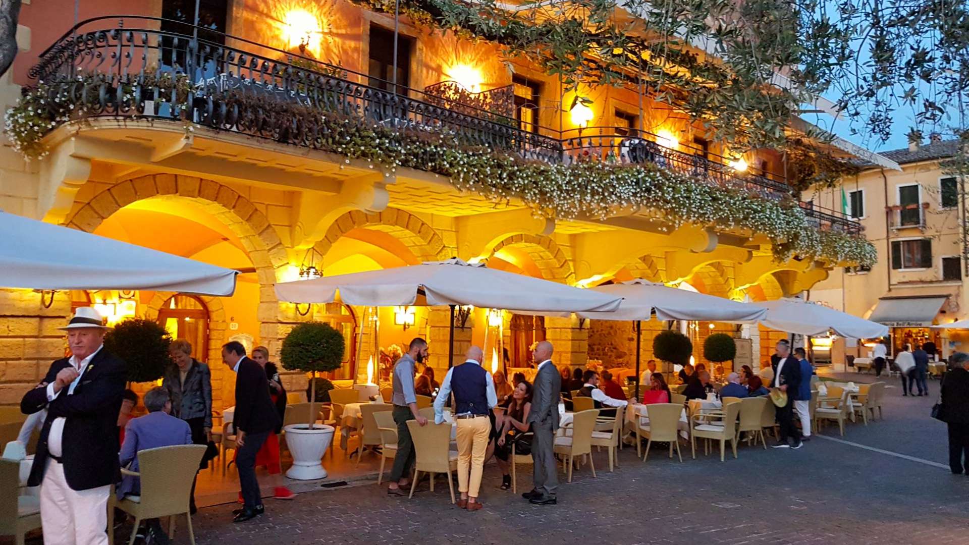 The arcades of the Gardesana lit at dusk